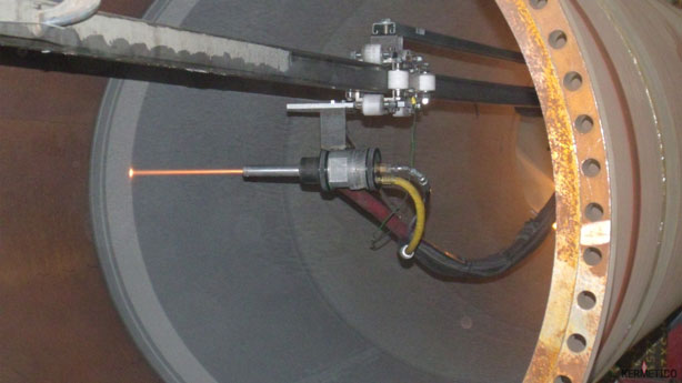 Temperature sensor probe extending into a large cylindrical metal vessel with visible wiring.