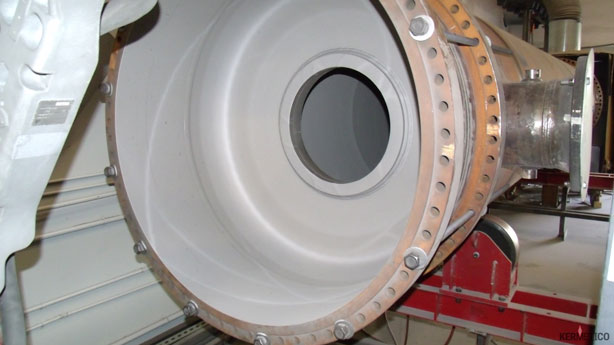Close-up of a large circular metal housing with a bolt flange and central bore.