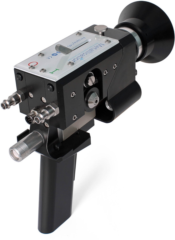 Handheld precision instrument with a black pistol-grip handle and a metallic control unit featuring knobs and connectors.