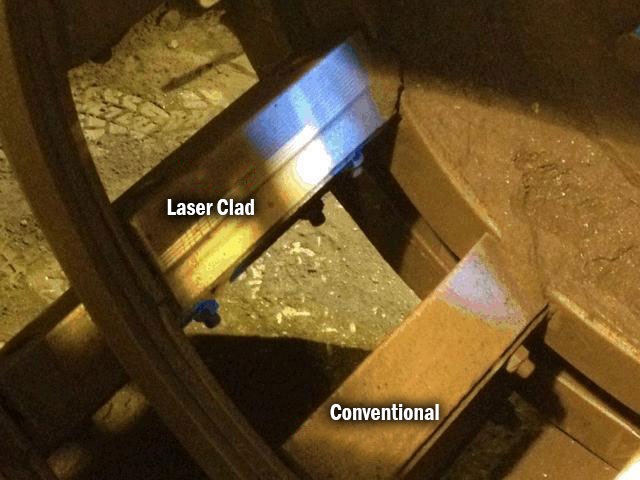 Close-up view of a metal component showing a laser-clad surface next to a conventional surface.