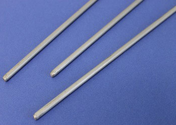 Three parallel stainless steel rods on a blue background.