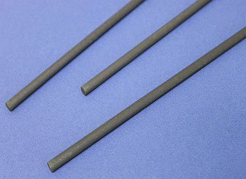 Three dark cylindrical rods on a blue background, arranged diagonally.