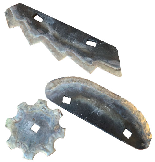 Three rusty metal parts with square openings—a jagged zigzag blade, a curved strip, and a small round cog.