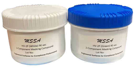 Two small plastic jars with white and blue lids labeled MSSA, containing masking compound.