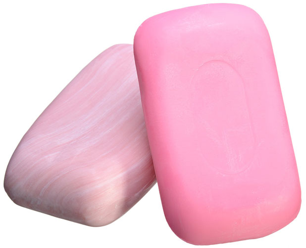 Two pink bar soaps on a white background, with one leaning against the other.
