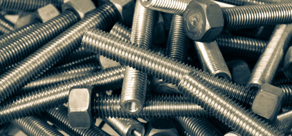 A pile of metal bolts with hexagonal heads and visible threading.