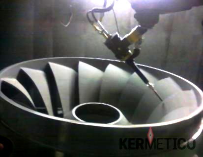 Robotic arm with a cutting tool working on a circular turbine impeller with curved blades.